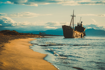 Rusty broken shipwreck on sea shore