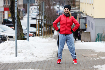 Fototapeta premium Woman wearing sportswear exercising outside during winter