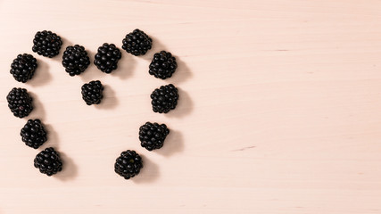 Fresh berries of blackberry in form heart