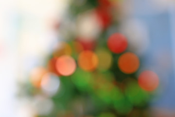 Blurred colorful bokeh lights on Christmas tree background.