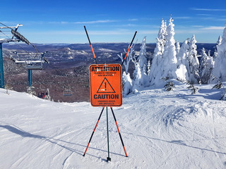 Caution sign and warning on a ski resort