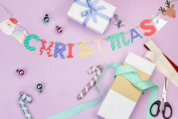 Cute colourful Christmas concept flat lay photo include candy garland gift box and ornament balls