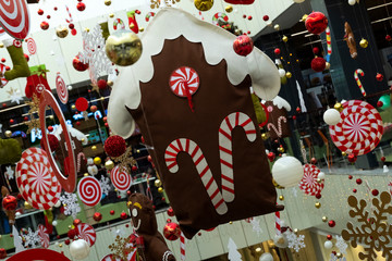 Obraz premium Festive decor of the house among other Christmas decorations. Abstract background of New Year's decoration in the store, airport or station room.