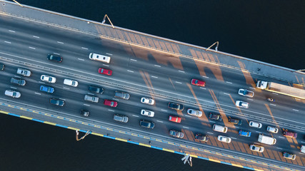 Aerial top view of bridge road automobile traffic jam of many cars from above, city transportation concept

