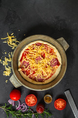 pizza, dough, ingredients, pepperoni, cheese, toatny sauce (cooking process). Top view with copy space