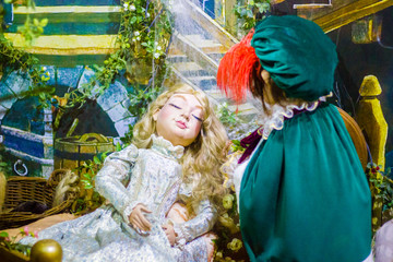 Sleeping beauty doll from the fairy tale is sleeping while the prince is checking on her and falls...