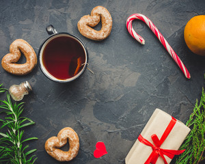 tea, cup, gingerbread, caramel, gifts for the holiday. Brewed tea bag, cup of tea and a festive atmosphere. top view. copy space