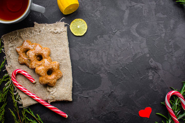 tea, cup, gingerbread, caramel, gifts for the holiday. Brewed tea bag, cup of tea and a festive atmosphere. top view. copy space
