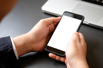 Cropped shot businessman in suit using mockup smartphone.