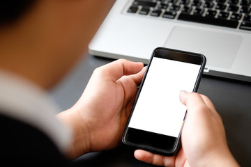 Cropped shot businessman in suit using mockup smartphone.