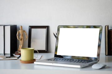 Mockup laptop computer and office supply on workspace and selective focus.