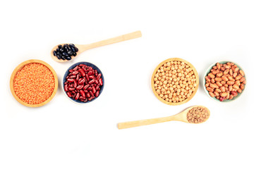 Various pulses, shot from the top on a white background with a place for text. Red kidney, pinto, and black beans, lentils, and chickpeas, forming a frame