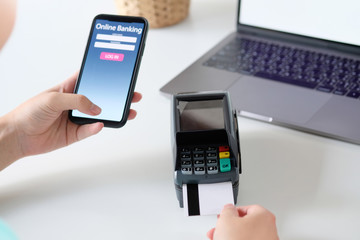 Man working on a laptop and uses credit card, Business and hand Swiping Credit Card