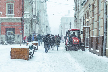 snowstorm in city. cleaning streets of snow