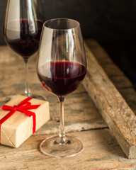 wine, red wine, transparent glass on a wooden table, a gift. Top view. copy space