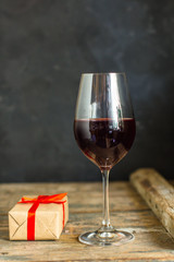 wine, red wine, transparent glass on a wooden table, a gift. Top view. copy space
