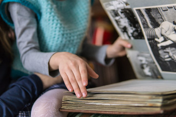 little girl leafing through a family album