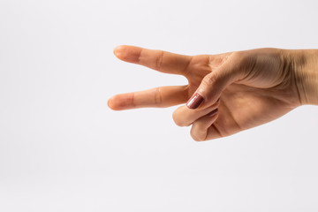 Woman's hand showing symbol of the scissors.