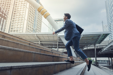 Businessman running up to stair in city,Growth of business concept
