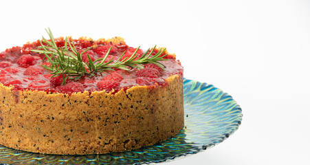 Raspberry cheesecake on the decorative plate. Isolated on white background up close.