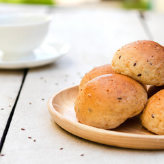 freshly baked bread and egg on white wooden background.