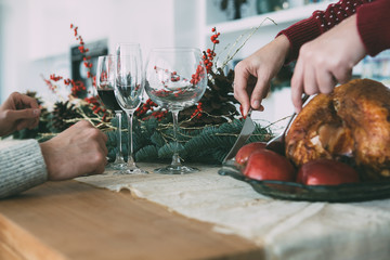 Woman hands carving a roasted turkey