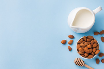 Almonds in a bowl and milk on the table. Selective focus. Copy space.