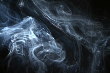 beautiful abstract contrast blue smoke against the dark background.