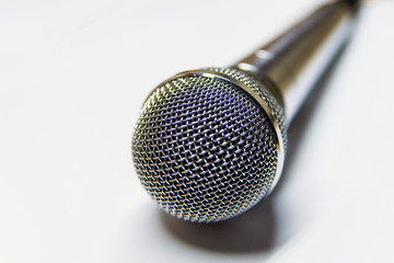 Silver audio microphone on white background