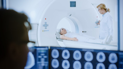 In Medical Laboratory Patient Undergoes MRI or CT Scan Process under Supervision of Radiologist, in...