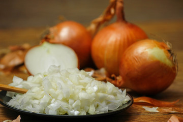 Onion and onion sliced on a rustic wood table. Close-up photo of healthy food.