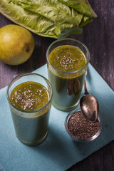 green smoothie with fruits and vegetables on black background