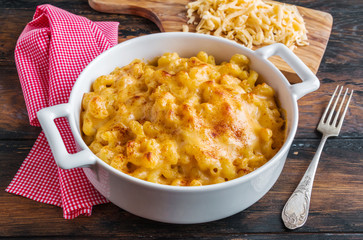 American dish Mac and Cheese pasta in white casserole on wooden rustic table. - 236238623