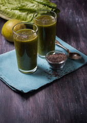green smoothie with fruits and vegetables on black background. S