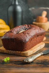 Chocolate banana bread and fresh fruits on wooden rustic table