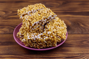 Peanut brittles in plate on wooden table