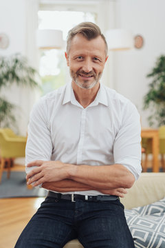 Friendly middle-aged man with crossed arms