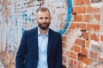 Entrepreneurial man wearing suit in urban setting - Powered by Adobe