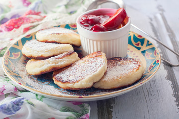 Homemade cottage cheese pancakes with berry-fruit sauce.