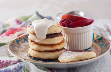 Homemade cottage cheese pancakes with berry-fruit sauce and sour
