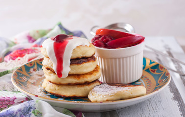 Homemade cottage cheese pancakes with berry-fruit sauce and sour