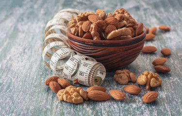 The concept of a healthy lifestyle, nuts  and measuring meter