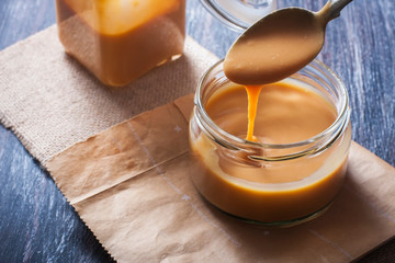 Homemade caramel sauce in a glass jar