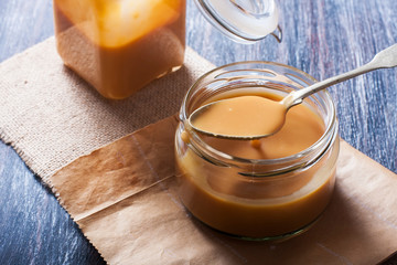 Homemade caramel sauce in a glass jar