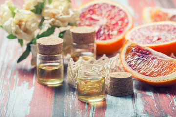Essential oil citrus  with orange slices,  in glass bottle on ol