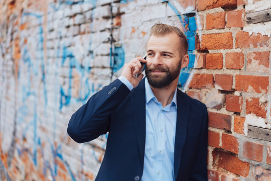 Young man smiling while talking on mobile phone