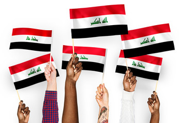 Hands waving flags of Iraq