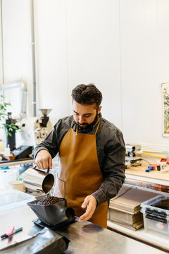Small business owner working in his coffee roaster shop