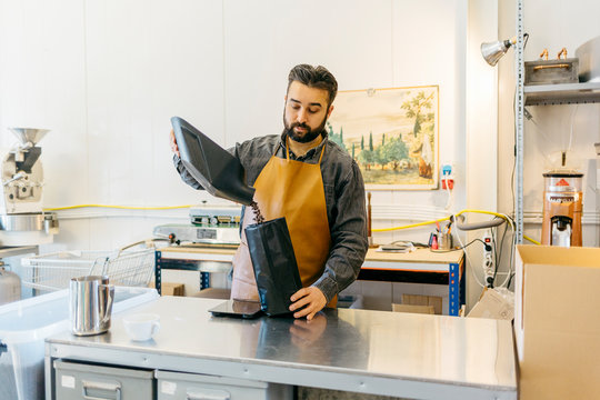 Small business owner working in his coffee roaster shop
