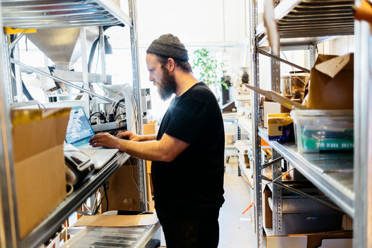 A coffee roaster using a laptop in Sweden